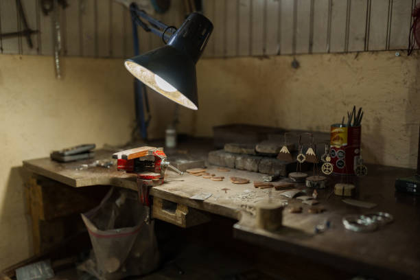 istock Jeweler's workbench illuminated by a lamp, displaying tools and handcrafted jewelry 2190116822