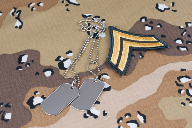 istock US ARMY Sergeant rank patch and dog tags on desert camouflage uniform 2190117970