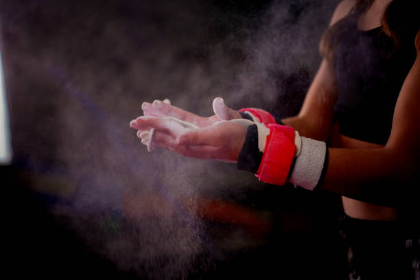 Focus on gymnast using magnesium carbonate (gymnast's powder), Focus on the hand of a child gymnast using magnesium carbon