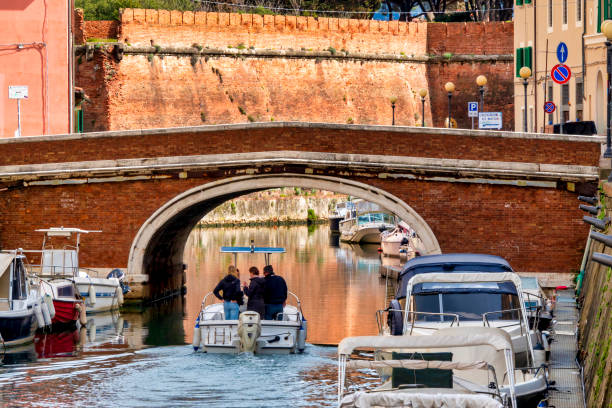 Venice, Italy - June 2nd 2024:  Water taxi in a cannel in Venice. Motorboats are a very popular way of transport in Venice - far more than gondolas - because they are cheaper and faster