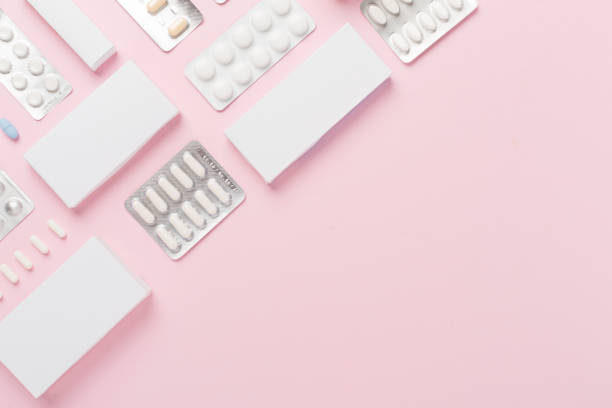 istock Flat lay with different pills in blister packaging and boxes and on color background 2190125930