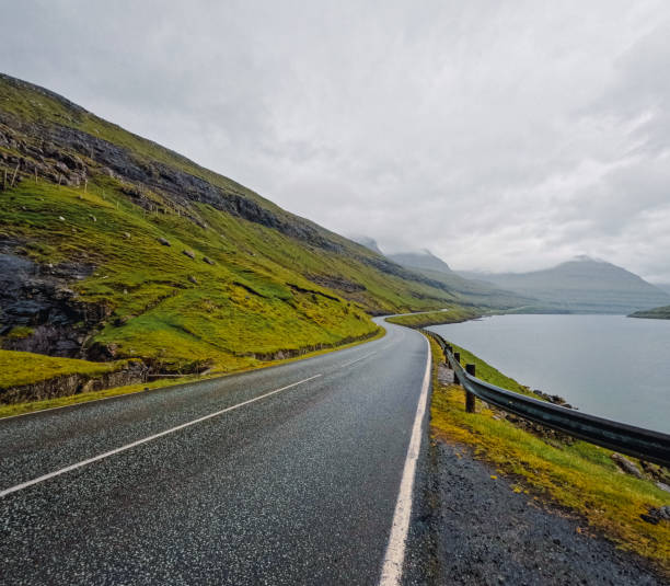 istock Curved Coastal Road Runs Between the Mountains and the Sea 2190126674