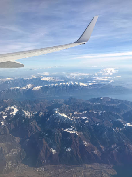 istock Airplane wing view during a flight over snow covered mountain peaks 2190128286