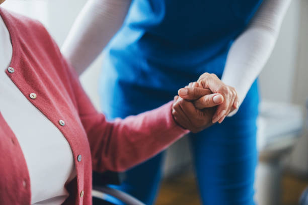 Caring Healthcare Professional Assisting Elderly Woman Through Compassionate Interaction