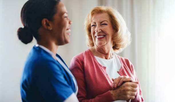 istock Cheerful Care Provider Supporting Elderly Woman in a Bright, Happy Environment 2190128638