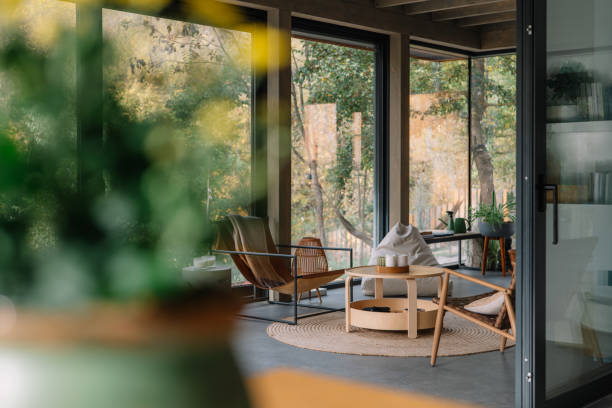 Modern wooden cabin interior with natural light and scenic forest view
