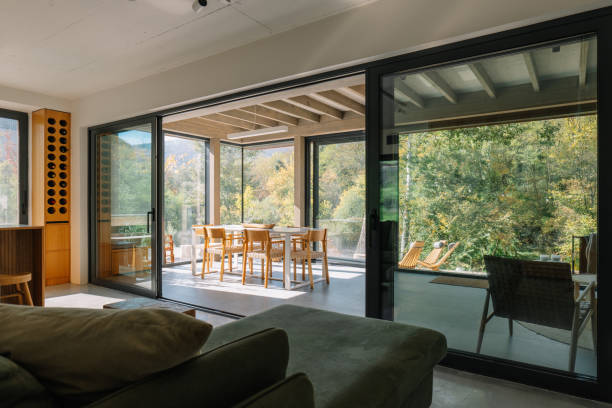 istock Modern wooden cabin interior with natural light and scenic forest view 2190129668