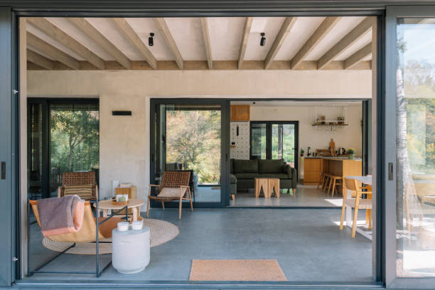istock Modern open-concept wooden cabin interior with living room and kitchen view 2190129669