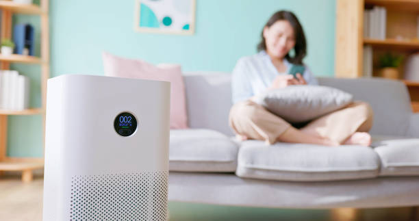 istock woman use air purifier home 2190129849