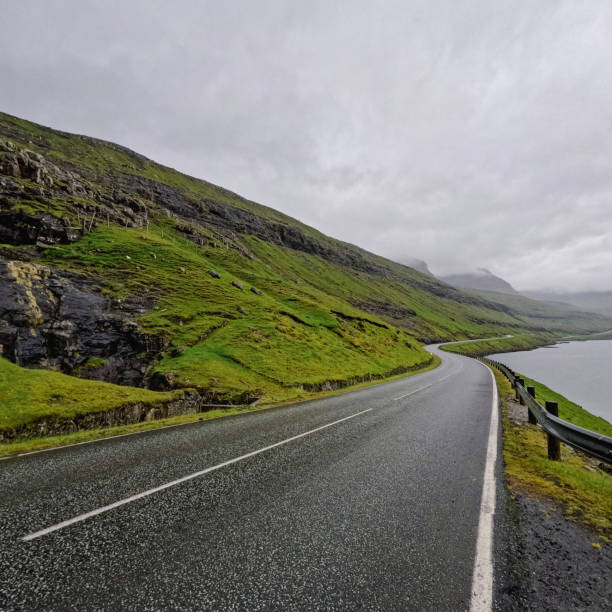 istock Curved Coastal Road Runs Between the Mountains and the Sea 2190129967