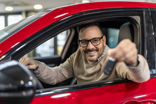 istock Happy man with keys to his new red car 2190131762
