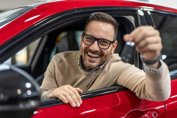 istock Happy man with keys to his new red car 2190131772