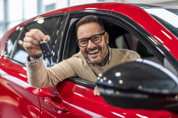 istock Happy man with keys to his new red car 2190131780