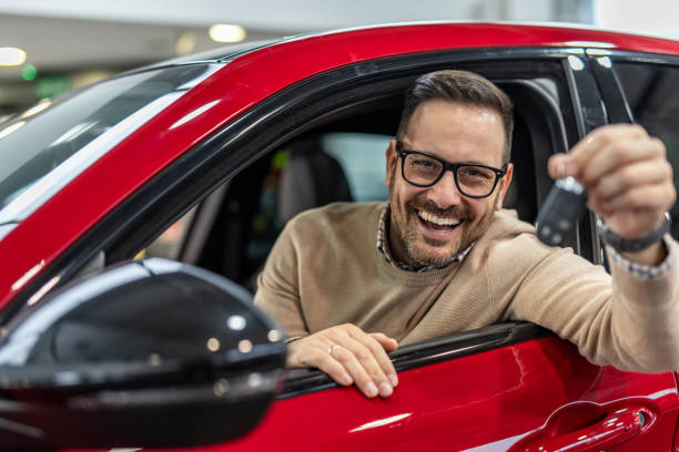 istock Happy man with keys to his new red car 2190131781