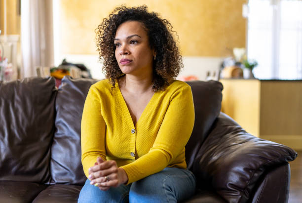 istock A sad woman sitting on a sofa 2190133625