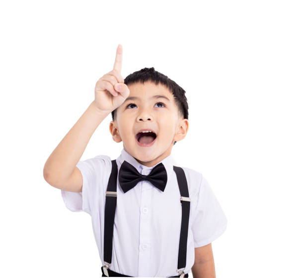 istock cute school boy pointing to empty place on white background 2190146784