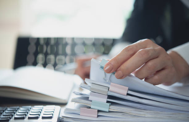 istock Document management. Businesswoman working with stack of paper files for searching and checking corporate files, document achieves on folders paper on office table, closeup 2190147709