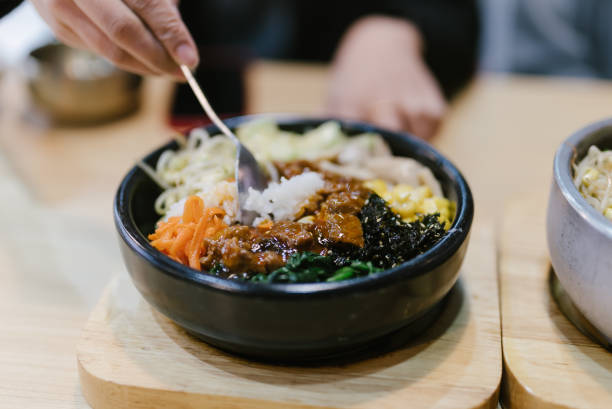 istock Bibimbap, rice and kimchi, vegetables, eggs and beef served in a stone casserole, South Korea's most famous fast food dish 2190150033