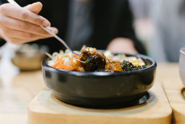 Bibimbap, rice and kimchi, vegetables, eggs and beef served in a stone casserole, South Korea's most famous fast food dish