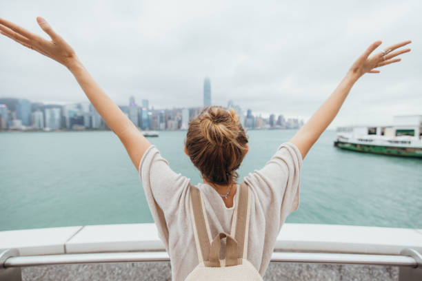 istock Woman Celebrating Cityscape View with Arms Outstretched 2190152009