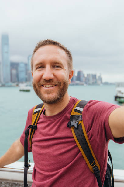 istock Man Taking Selfie with Urban Skyline in Background 2190152500