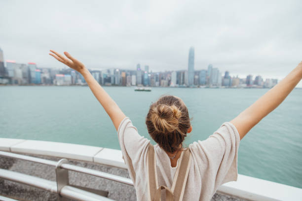 istock Woman Embracing Cityscape View from Waterfront 2190152561