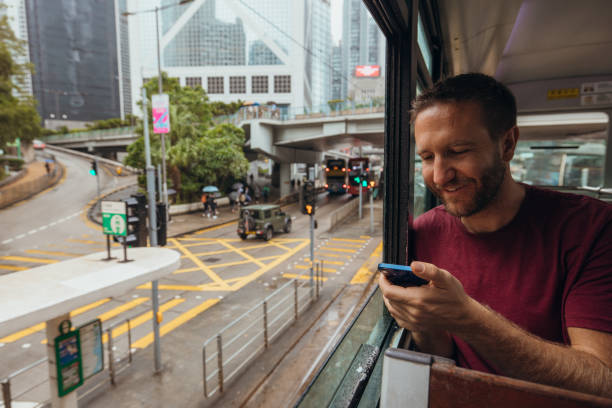 istock Man Enjoying Scenic City View from Tram Window 2190152741