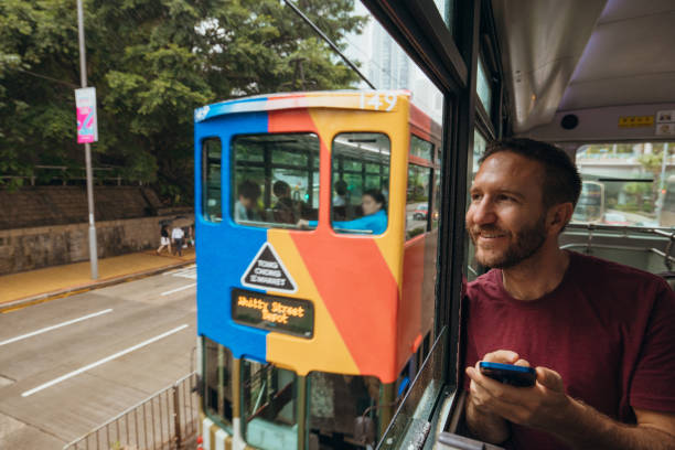istock Man Enjoying Scenic City View from Tram Window 2190152743