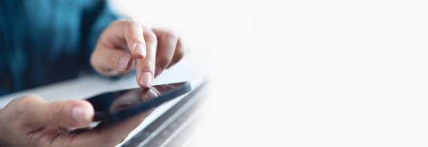 istock Closeup, woman using mobile phone with copy space. Business woman surfing the internet, using smartphone, working on laptop computer at office 2190155263