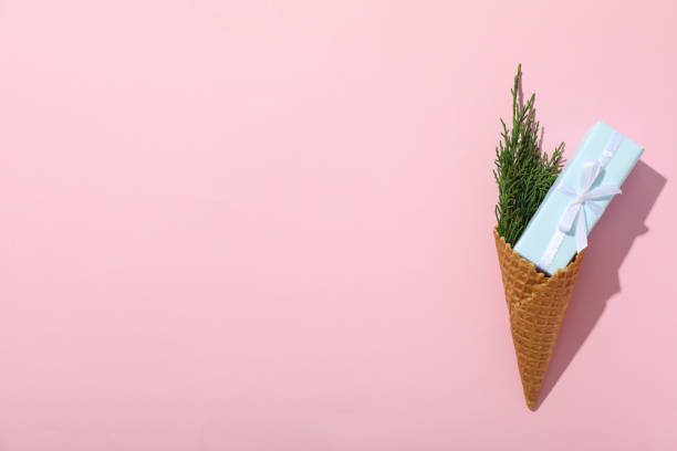 istock Waffle cone with a gift and a sprig of needles 2190155402