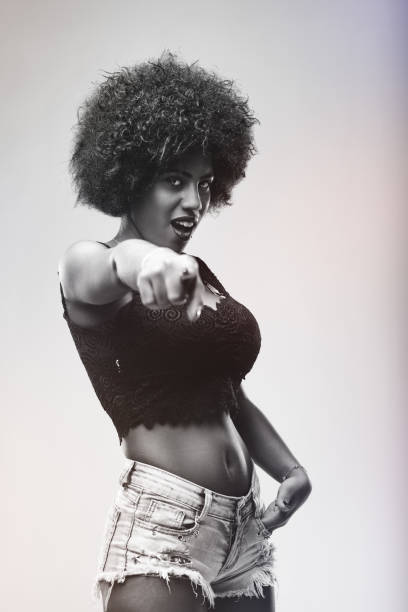 istock Young woman pointing finger and looking at camera 2190156853