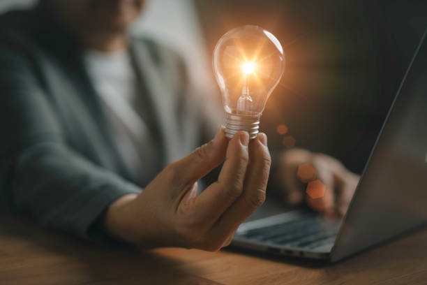 istock A woman holding light bulb and using computer laptop for  new idea  with innovation and inspiration, innovative technology   and modern communication 2190156928