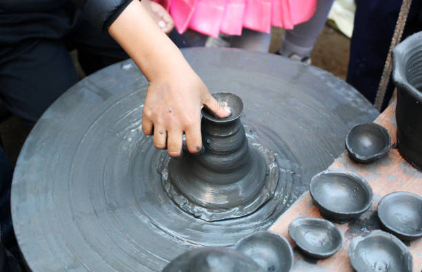 istock A young hand shaping clay on a spinning pottery wheel, highlighting traditional art, creativity, and hands-on learning in pottery making. 2190157088