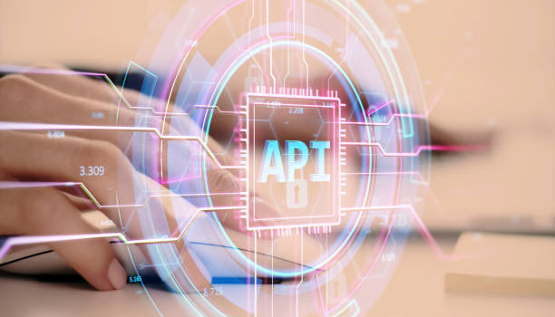 istock Digital API hologram interface overlaying hands typing on keyboard in a business environment. 2190159014