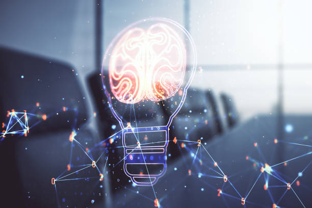istock Abstract virtual creative light bulb with human brain hologram on a modern boardroom background, artificial Intelligence and neural networks concept. Multiexposure 2190159058