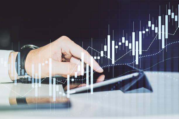 istock Abstract creative financial graph with finger clicks on a digital tablet on background, financial and trading concept. Multiexposure 2190159077