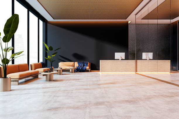 istock Modern office reception area with elegant design, beige sofas, wooden accents, large glass windows, and a clean, minimalist counter. 3D Rendering 2190159101