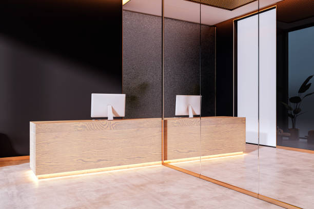 istock Modern reception desk with wooden counter and illuminated base in luxurious office interior with glass walls and black accents. 3D Rendering 2190159118