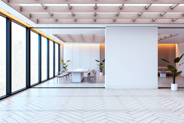 istock Modern empty conference room with glass partitions, wooden ceiling, and chevron floor in a bright high-rise office building interior. 3D Rendering 2190159156