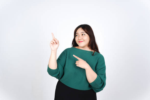 istock Smiling Presenting and Pointing aside at copy space for Advertising showing Product Of Beautiful Asian Woman Isolated On White Background 2190161187