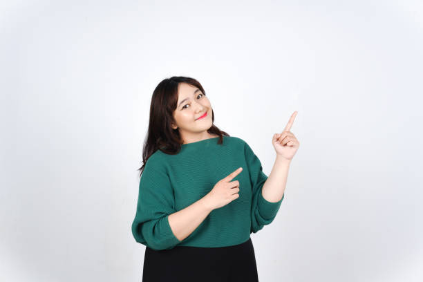 istock Smiling Presenting and Pointing aside at copy space for Advertising showing Product Of Beautiful Asian Woman Isolated On White Background 2190161230