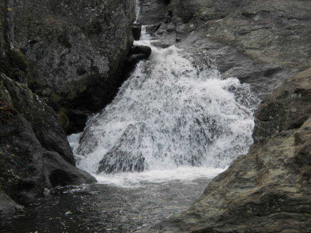 Waterfall with cliffs in the background at Cunningham falls State Park in Maryland..