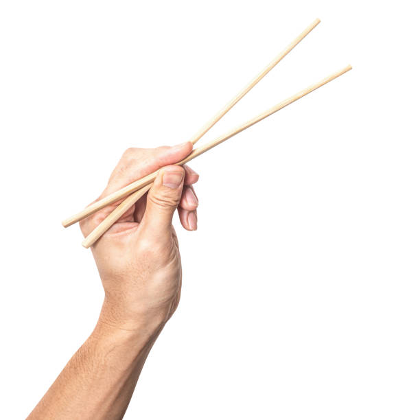 istock Male hand holding a wood chopstick isolated on white background. 2190164332