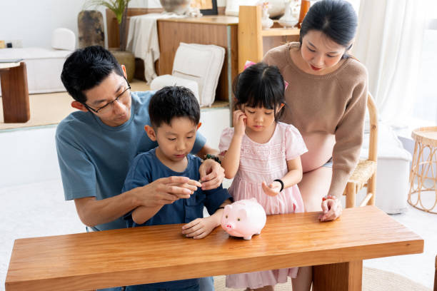 istock Family Moments: Learning to Save with a Piggy Bank 2190168649