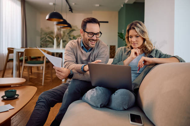 istock Mid adult couple using laptop while going through their home finances. 2190169091