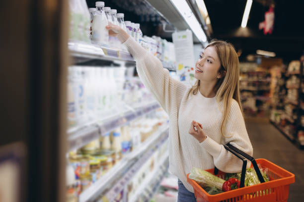 istock Customer choosing milk bottle from shelf in supermarket 2190169113