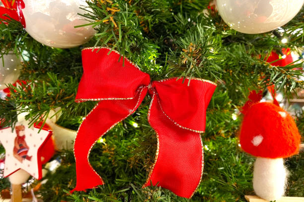 istock Festive Christmas Tree with Red Bow and Ornaments for Holiday Decor 2190169151