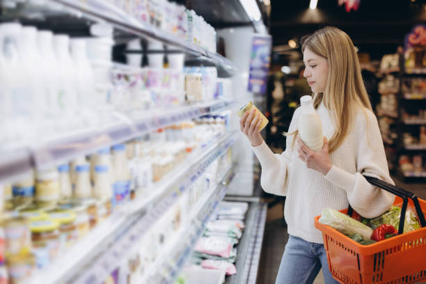 istock Customer choosing products in supermarket dairy section 2190169178