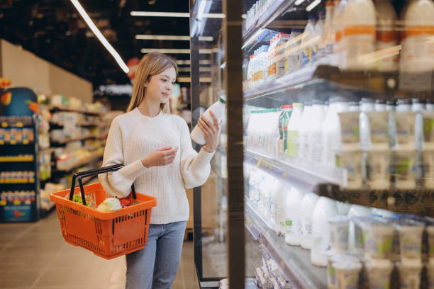 istock Customer choosing milk products in supermarket refrigerator 2190169348