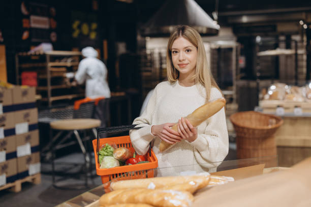 istock Woman choosing fresh bread in supermarket bakery section 2190169406